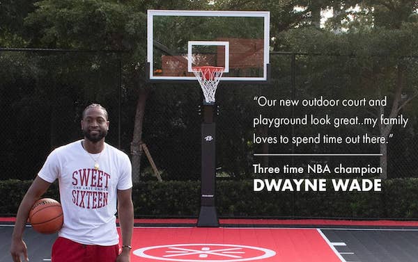 picture of 3-time NBA champion Dwayne Wade standing in front of his Ryval Hoops basketball goal